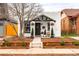 Charming home featuring a landscaped front yard, well maintained garden beds, and a welcoming entrance at 1452 S Logan St, Denver, CO 80210