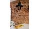 Close up of the kitchen featuring modern light fixtures, white counters, and exposed brick wall at 1452 S Logan St, Denver, CO 80210