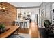 Modern kitchen with white cabinetry, stainless steel appliances, and exposed brick accents at 1452 S Logan St, Denver, CO 80210