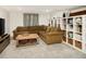 Cozy living room features a plush sectional sofa, stylish shelving, and soft, neutral carpet at 1452 S Logan St, Denver, CO 80210