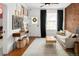 Bright living room with gallery wall, hardwood floors, and comfortable seating at 1452 S Logan St, Denver, CO 80210