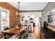 Cozy living room with exposed brick wall, open to kitchen and dining areas at 1452 S Logan St, Denver, CO 80210