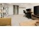 Open-concept living space with an office area, plush seating, and stylish shelving at 1452 S Logan St, Denver, CO 80210