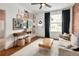 Inviting living room with art display, wood floors, and bright natural light at 1452 S Logan St, Denver, CO 80210