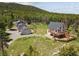 Aerial view of the home, outbuildings, and the large acreage surrounding the home at 31551 Black Widow Dr, Conifer, CO 80433