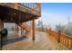 Spacious outdoor deck with wooden railings and stairs, ideal for entertaining or relaxing at 31551 Black Widow Dr, Conifer, CO 80433
