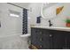 Bright bathroom with white tile, a black vanity with gold hardware, and a modern toilet at 31551 Black Widow Dr, Conifer, CO 80433