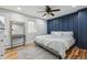 Charming bedroom featuring an accent wall, modern furniture, hardwood floors, and bright natural light at 31551 Black Widow Dr, Conifer, CO 80433
