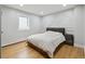 Serene bedroom with geometric accent wall, hardwood floors, and a cozy atmosphere, ideal for relaxation at 31551 Black Widow Dr, Conifer, CO 80433