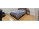 Cozy bedroom with hardwood floors, a comfortable bed, and a globe on the bedside table at 31551 Black Widow Dr, Conifer, CO 80433