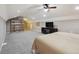 Large bedroom with a bed, built-in shelving, a tv, and neutral colored carpet at 31551 Black Widow Dr, Conifer, CO 80433