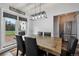 Bright dining room with modern lighting and a rustic wood table, perfect for gatherings at 31551 Black Widow Dr, Conifer, CO 80433