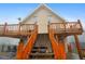 Inviting exterior featuring a log staircase and deck leading to the home's entrance at 31551 Black Widow Dr, Conifer, CO 80433