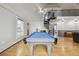 Well-lit game room with a billiards table and spiral staircase leading to an upper level at 31551 Black Widow Dr, Conifer, CO 80433