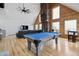 Bright game room featuring a billiards table, wood floors, and an eye-catching fan at 31551 Black Widow Dr, Conifer, CO 80433