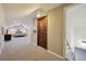 Hallway leading to bedroom with an arched ceiling, recessed lighting, and neutral carpet at 31551 Black Widow Dr, Conifer, CO 80433