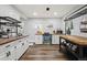 Bright kitchen with white cabinets, stainless steel appliances, and butcher block countertops at 31551 Black Widow Dr, Conifer, CO 80433