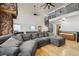 Relax in this living room featuring a large sectional, pool table, soaring ceilings, and a unique spiral staircase at 31551 Black Widow Dr, Conifer, CO 80433