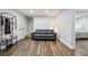 Cozy living room features a leather couch, hardwood floors, and bright natural light at 31551 Black Widow Dr, Conifer, CO 80433