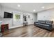 Spacious living room featuring hardwood floors, a comfortable couch, and ample natural light at 31551 Black Widow Dr, Conifer, CO 80433