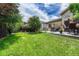 Manicured backyard featuring a spacious lawn, patio with seating, and mature trees for added privacy at 2868 Breezy Ln, Castle Rock, CO 80109
