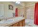 Well-lit bathroom featuring a tiled shower/bath, vanity, and neutral color scheme at 2868 Breezy Ln, Castle Rock, CO 80109
