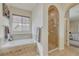 Bathroom featuring a soaking tub, tiled shower, and neutral colors creating a tranquil spa-like experience at 2868 Breezy Ln, Castle Rock, CO 80109