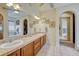 Bright bathroom features double sinks and vanity, tile floors, and decorative mirrors creating a stylish space at 2868 Breezy Ln, Castle Rock, CO 80109