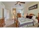 Sunlit bedroom showcasing a beautiful bed and a view of an arched hallway, offering a peaceful retreat at 2868 Breezy Ln, Castle Rock, CO 80109