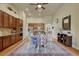 Dining area with wooden floors, an area rug, and wood cabinets. A kitchen can be seen through the archway at 2868 Breezy Ln, Castle Rock, CO 80109