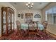Charming dining room with hardwood floors, decorative china cabinet, and a round table set for a meal at 2868 Breezy Ln, Castle Rock, CO 80109