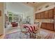 Open dining area with adjacent kitchen and a view of the spacious living room with large windows at 2868 Breezy Ln, Castle Rock, CO 80109