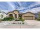 Charming stucco home with beautiful landscaping, rock features, and an attached two-car garage at 2868 Breezy Ln, Castle Rock, CO 80109