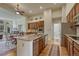 Updated kitchen with stainless appliances, granite counters, wooden cabinets, and open layout to the dining area at 2868 Breezy Ln, Castle Rock, CO 80109