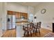 Bright kitchen with stainless steel appliances, breakfast bar, granite countertops, and wooden cabinets at 2868 Breezy Ln, Castle Rock, CO 80109