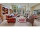 Inviting living room with large windows, a stone fireplace, plush seating, and carpet floors at 2868 Breezy Ln, Castle Rock, CO 80109