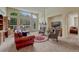 Bright and airy living room with large windows, a stone fireplace, plush seating, and carpet floors at 2868 Breezy Ln, Castle Rock, CO 80109