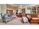 Open concept living room with a fireplace, hardwood floors, plush furniture, and neutral decor at 2868 Breezy Ln, Castle Rock, CO 80109