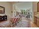 Spacious living room with hardwood floors, large windows, and an open layout to the dining area at 2868 Breezy Ln, Castle Rock, CO 80109