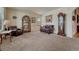 Comfortable living room with neutral carpet, an antique grandfather clock, and leather furniture at 2868 Breezy Ln, Castle Rock, CO 80109