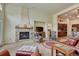 Spacious living room featuring a stone fireplace, comfortable seating, and an open layout at 2868 Breezy Ln, Castle Rock, CO 80109