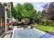 Cozy outdoor patio with comfortable seating, potted plants, and a decorative rug at 2868 Breezy Ln, Castle Rock, CO 80109