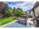Relaxing patio area with comfortable seating and a grill, perfect for outdoor entertaining and enjoying the serene backyard at 2868 Breezy Ln, Castle Rock, CO 80109