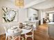Inviting dining area adjacent to the kitchen, featuring elegant decor and modern lighting at 888 S Valentia St # 102, Denver, CO 80247