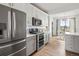 Well-lit kitchen boasting modern cabinets, stainless steel appliances, and a cozy dining area at 888 S Valentia St # 102, Denver, CO 80247