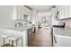 Open-concept kitchen featuring an island with seating and seamlessly connected to the living area at 888 S Valentia St # 102, Denver, CO 80247