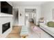 Open concept living area with fireplace and seamless flow into the kitchen and dining space at 888 S Valentia St # 102, Denver, CO 80247