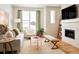 Bright living room with a fireplace, large windows, and stylish furnishings at 888 S Valentia St # 102, Denver, CO 80247