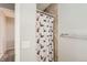 Simple bathroom with shower, tiled walls, and patterned curtain at 1475 S Quebec Way # H38, Denver, CO 80231