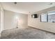 Well-lit bedroom with carpet, window, and built-in shelving at 1475 S Quebec Way # H38, Denver, CO 80231